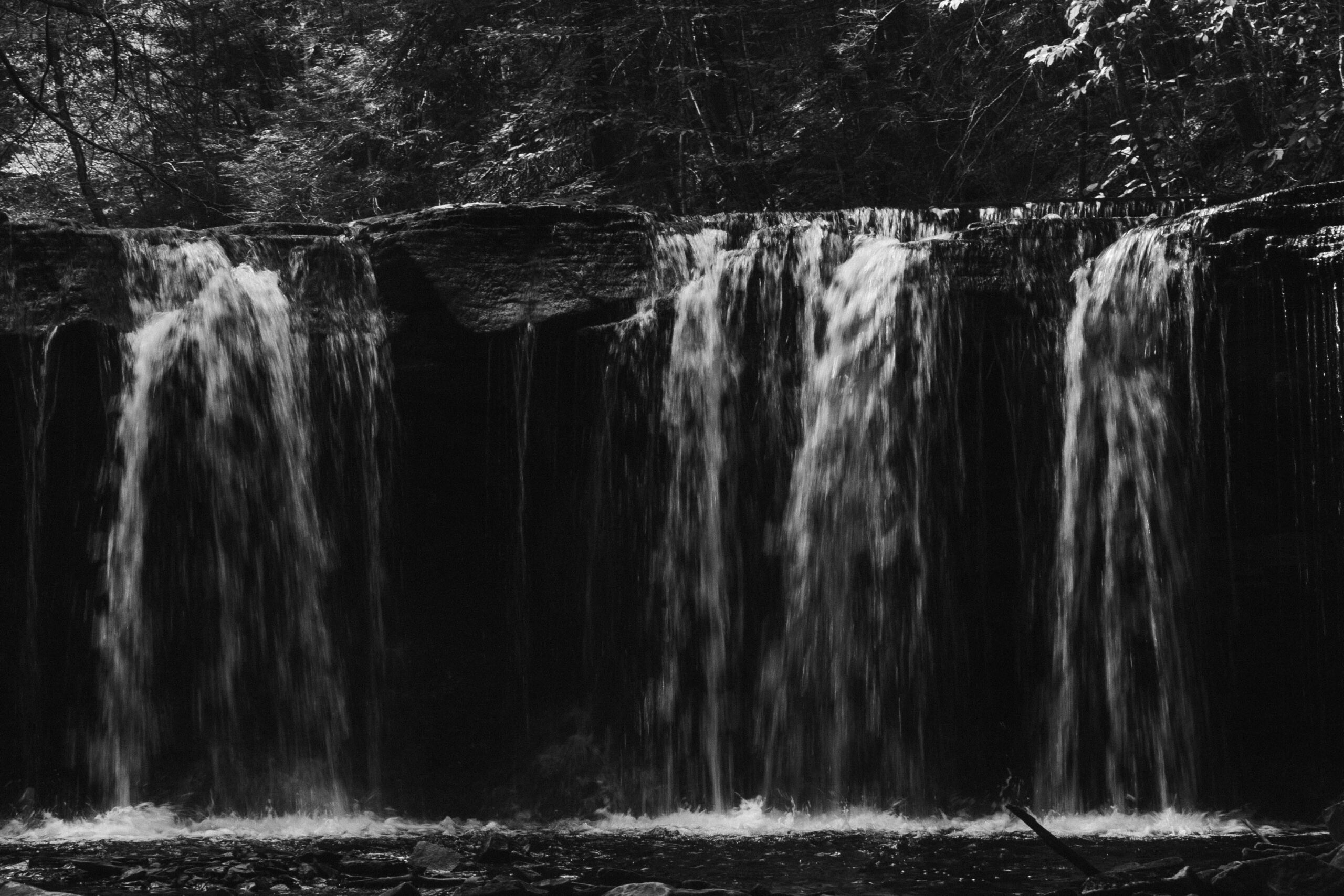 a small waterfall in black and white